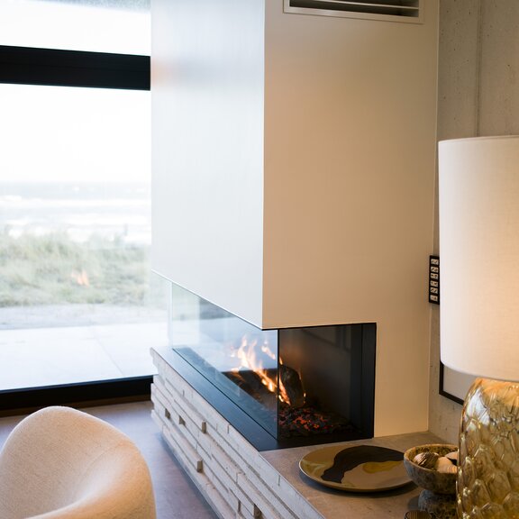 VISIO 160 three-sided gas fireplace insert with black steel frame and side bench