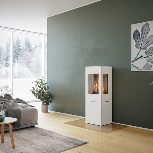 NEXO 120 GAS in white with steel door Gas stove NEXO 120 in white with steel door and two side windows in front of green wall in decorative living room