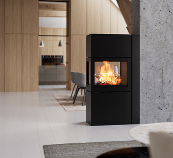 600 RD in black with steel door against a concrete wall 600 RD stove in black with steel door against a concrete wall in a modern living room