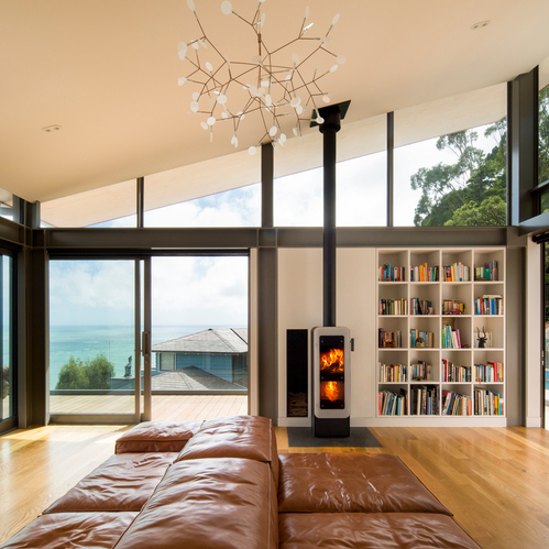 bionic fire EVO in black with white glass door Wood stove bionic fire EVO in the colour black with white glass door in the living room by the sea