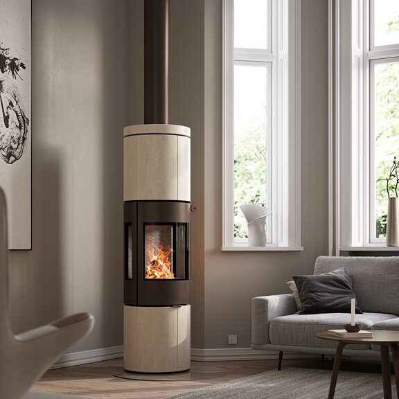 JUNO 166 L wood stove with natural stone «Porto» cladding and side windows in a modern living room in earth tones