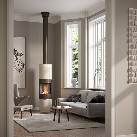 JUNO 166 L with natural stone «Porto» cladding and steel door in the colour mocha in a modern living room with large window fronts