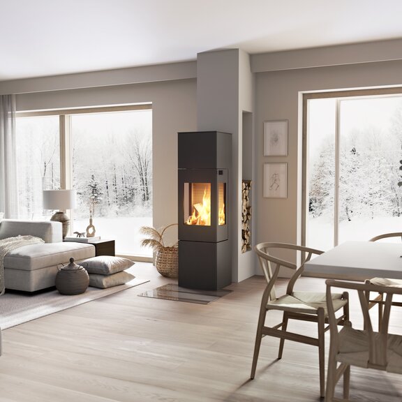 Wood stove NEXO 160 in black with steel door and side window in the centre of the living room between the dining area and living room