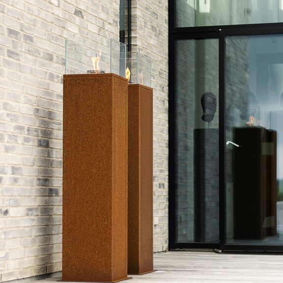 Biethanol fireplaces Nice on column on stone wall with window front