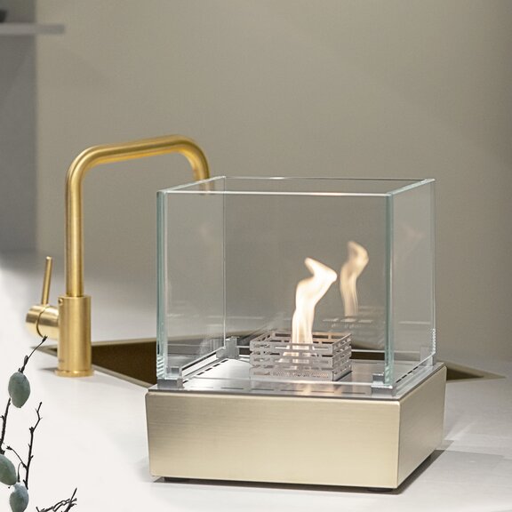 Nice bioethanol burner in kitchen next to golden tap