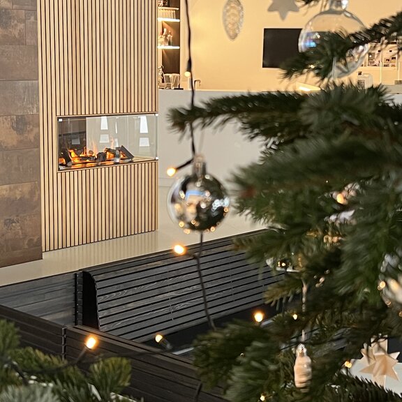Electric fire panel wall room divider in wood panelling with Christmas tree